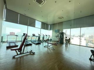 Modern gym with floor-to-ceiling windows overlooking the city