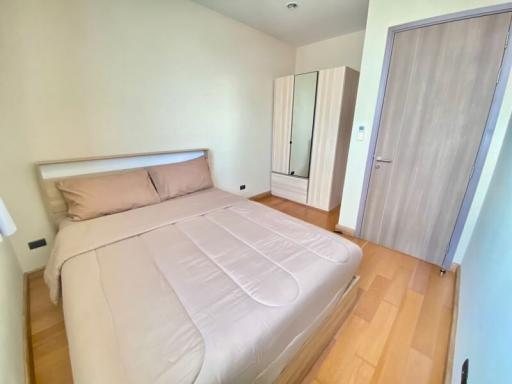 Bright bedroom with a double bed and wooden floor