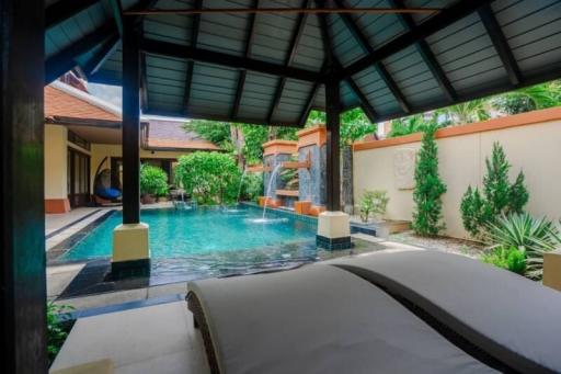 Luxurious private pool surrounded by lush garden and comfortable patio area