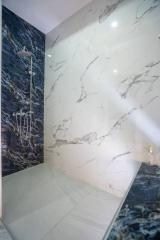 Modern marble bathroom with wall-mounted shower