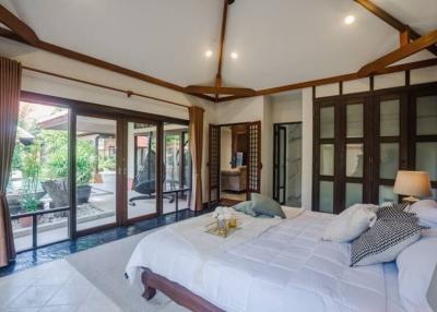 Spacious bedroom with direct access to pool area