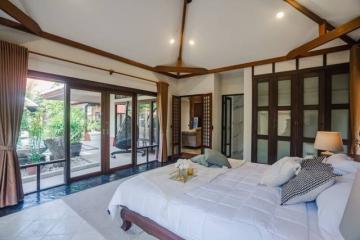 Spacious bedroom with direct access to pool area