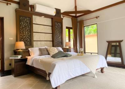 Spacious and elegantly decorated bedroom with ample natural light