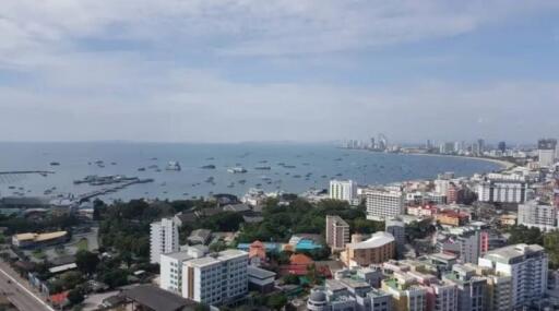 Aerial view of a coastal city with numerous buildings and boats on the water