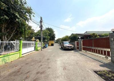 Exterior view of a residential property with a driveway and parked car