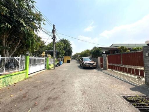 Exterior view of a residential property with a driveway and parked car