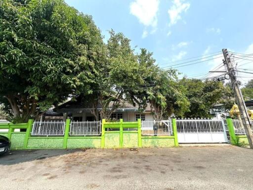 Exterior view of a residential home with a fenced yard