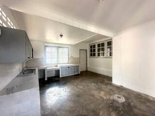 Spacious kitchen with natural light and potential for renovation