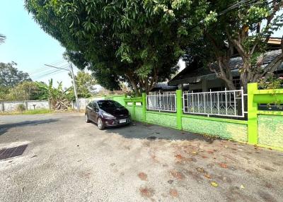 Suburban house front yard with parked car