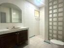 Spacious bathroom with white tiling and modern fixtures