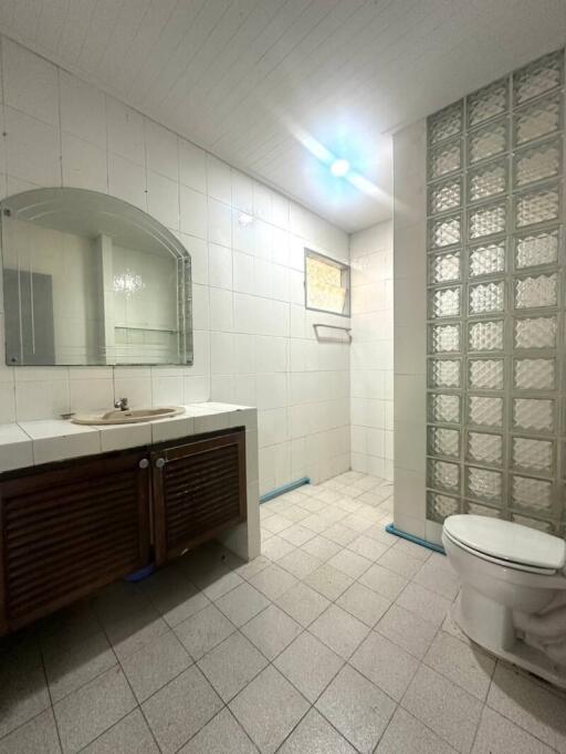 Spacious bathroom with white tiling and modern fixtures