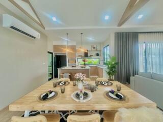 Modern open concept living space with dining area and view into the kitchen