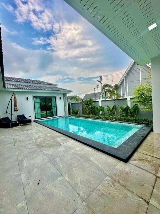 Contemporary Poolside Outdoor Area with Lush Greenery
