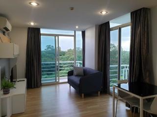 Spacious and well-lit living room with large windows and modern furniture