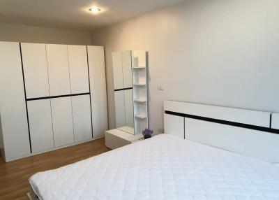 Spacious bedroom with large wardrobe and comfortable bed