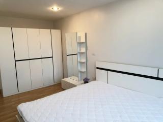 Spacious bedroom with large wardrobe and comfortable bed