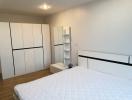 Spacious bedroom with large wardrobe and comfortable bed