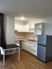 Modern kitchen with white cabinetry and wooden flooring