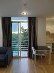 Modern living room with balcony access and hardwood floors