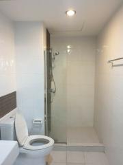 Modern bathroom with a glass shower enclosure and white tiles