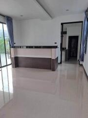 Modern kitchen space with attached bar counter and clean tile flooring