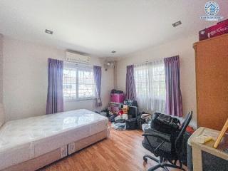 Spacious bedroom with natural light and storage space