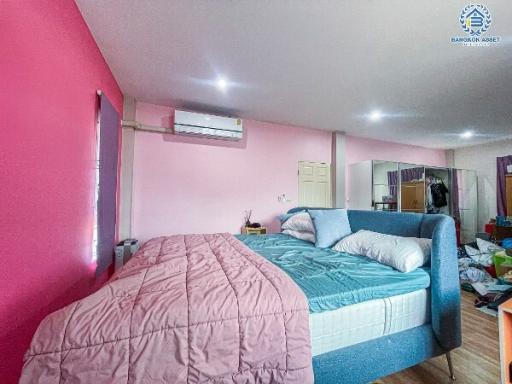 Spacious bedroom with a large bed and modern air conditioner