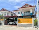 Modern two-story house with a secure garage and parked cars