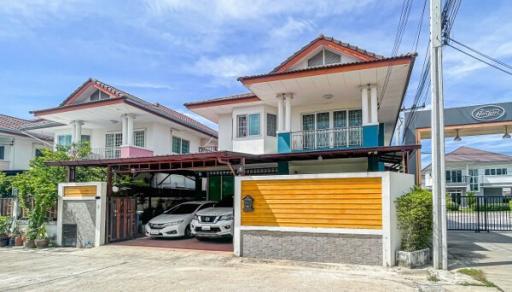 Modern two-story house with a secure garage and parked cars