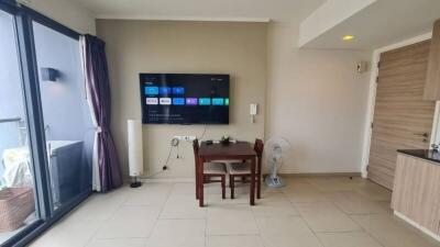 Spacious living room with modern amenities and balcony access