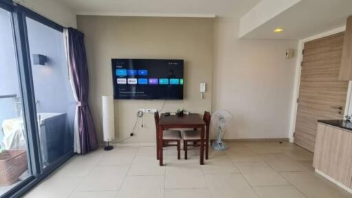 Spacious living room with modern amenities and balcony access