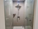 Modern bathroom with glass shower enclosure and beige tiles