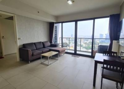 Spacious living room with large windows and city view