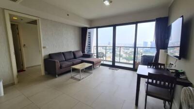 Spacious living room with large windows and city view