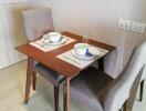 Cozy dining space with a wooden table and two chairs