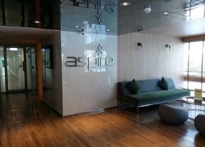 Modern lobby area with logo, comfortable seating and wooden flooring