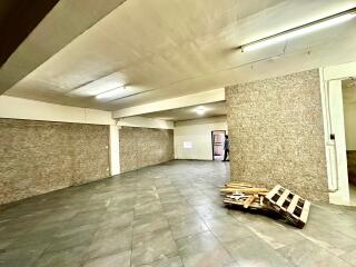 Spacious indoor garage with tiled flooring and bright lighting