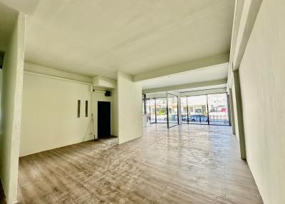 Spacious and well-lit living room with large windows and balcony access