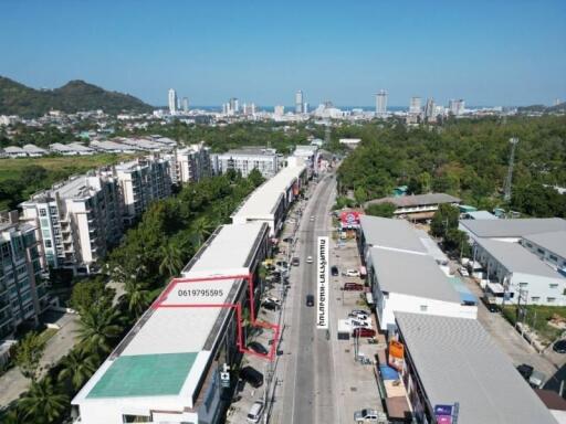 Aerial view of a busy street with residential and commercial buildings