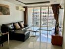 Spacious living room with large windows and balcony access