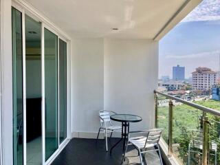 Spacious balcony with city view and outdoor seating