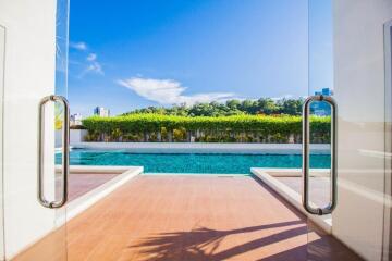 Luxurious pool area with clear blue water and sunny skies