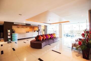 Spacious and well-lit lobby area with seating and reception desk