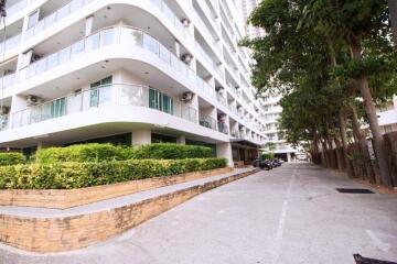 Modern residential building exterior with landscaped entryway