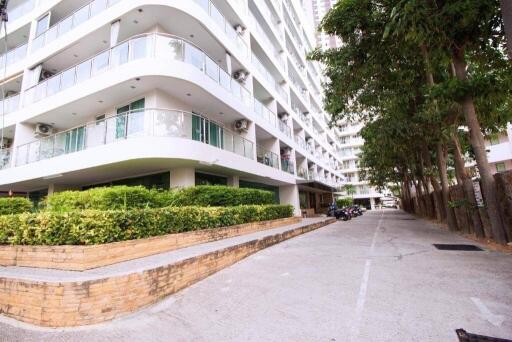 Modern residential building exterior with landscaped entryway