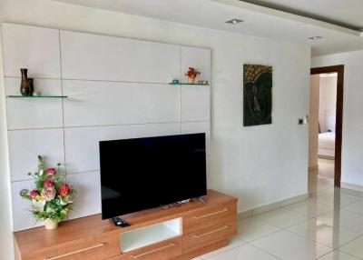 Modern living room interior with flat-screen TV and decorative shelving