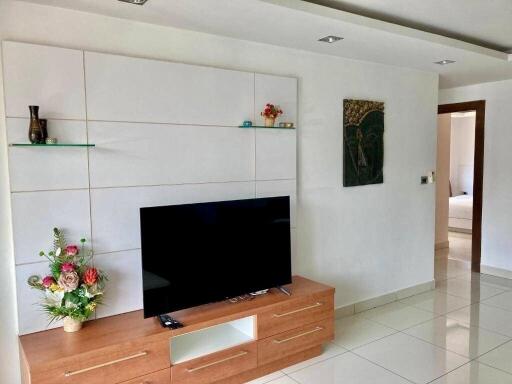 Modern living room interior with flat-screen TV and decorative shelving