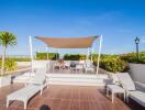 Spacious outdoor patio with furniture and ocean view