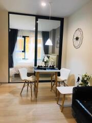 Modern dining space adjacent to the bedroom with glass partition