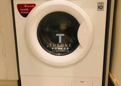 White front load washing machine in a home laundry room